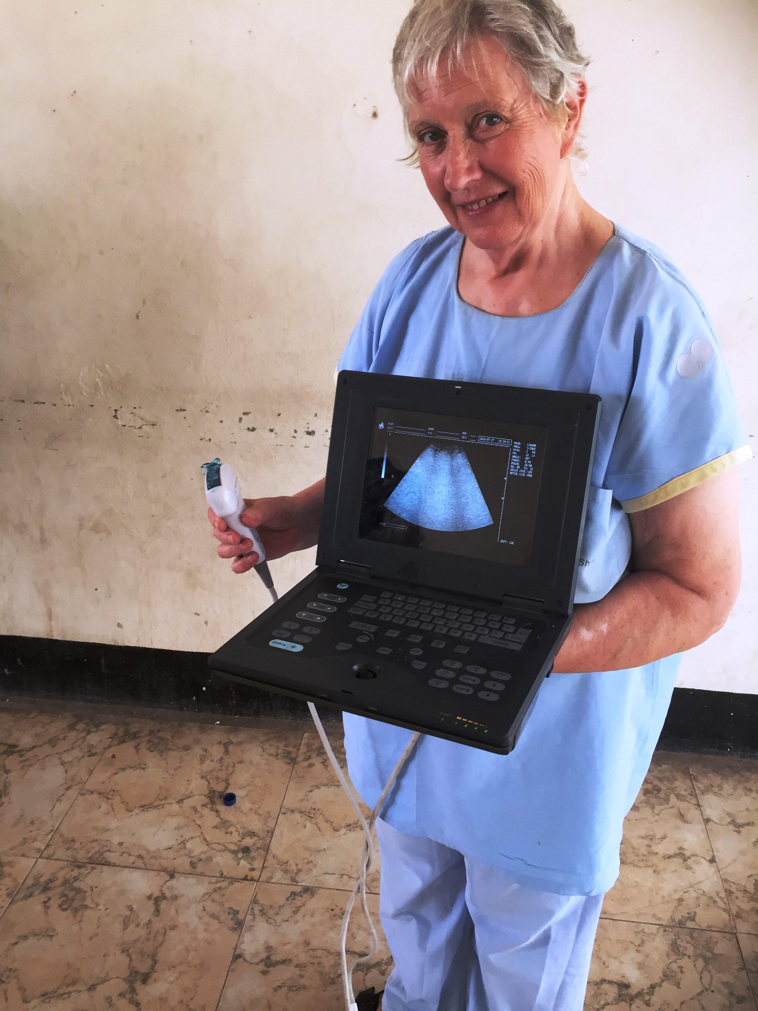 Dr. Margaret holds a portable ultrasound machine that was purchased with funds raised by the Can-Go Afar Foundation
