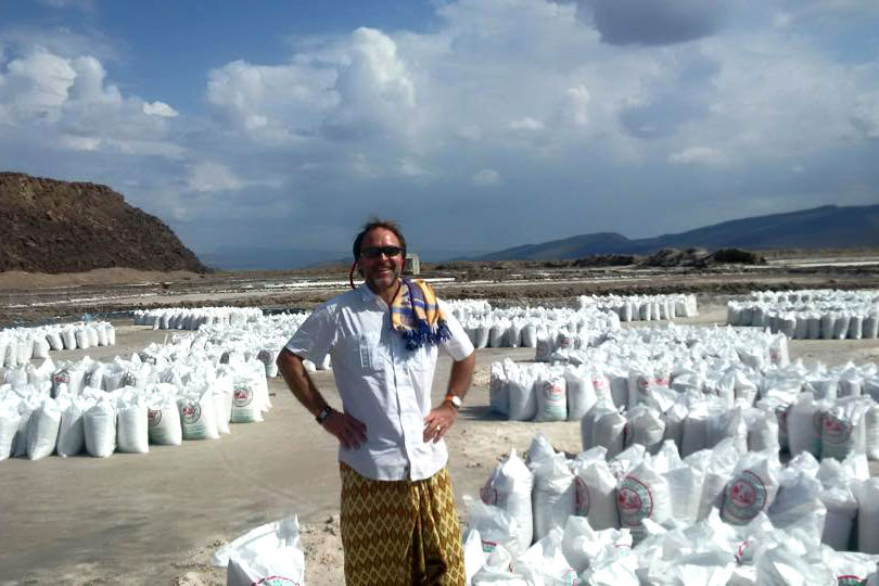 CGA's Warren Creates standing in front of bags of salt gathered by the Afar at the Lake Dobi Salt Pans in Ethiopia, near the border with Djibouti.