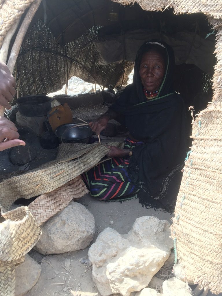 An Afar woman makes a traditional camel milk container